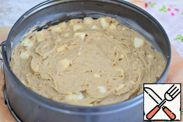 The bottom of the baking dish (d 20 cm) is lined with baking paper, the sides of the form are greased with vegetable or butter. Put the dough in the form, flatten.
