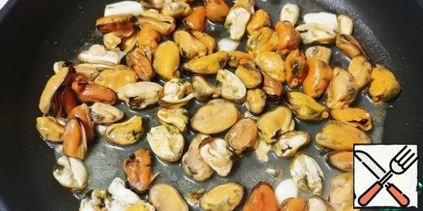 After 1-2 minutes, I added thawed and lightly pressed clams.