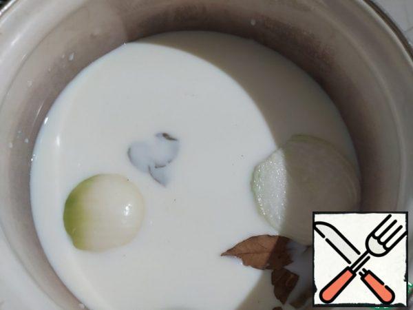 First of all, I recommend cooking flavored milk. Of course, you can skip this step and just use milk. But, with fragrant milk is very tasty.
So: in a saucepan with a thick bottom, pour the milk, add salt, Bay leaf, black pepper and nutmeg. 1 onion, cut in half. Put on the stove and bring to a boil. Then reduce the heat to a minimum and boil for another 5 minutes. Turn off, cover with a lid, and let it infuse for 20 minutes. Before using, strain the milk, removing the onion and Bay leaf.