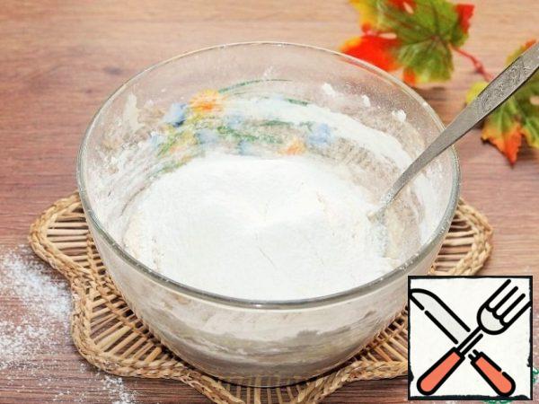 In the liquid mixture, add small parts of flour and knead the dough.