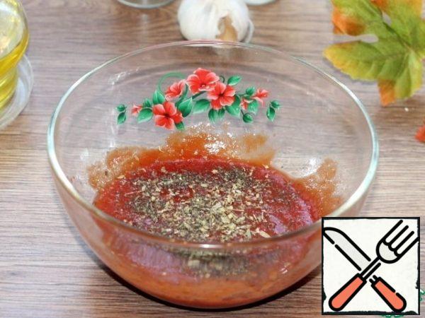 Prepare the sauce. Mix tomato paste with olive oil. Add the pressed garlic, a pinch of oregano and Basil, salt and pepper. You can add a pinch of sugar.