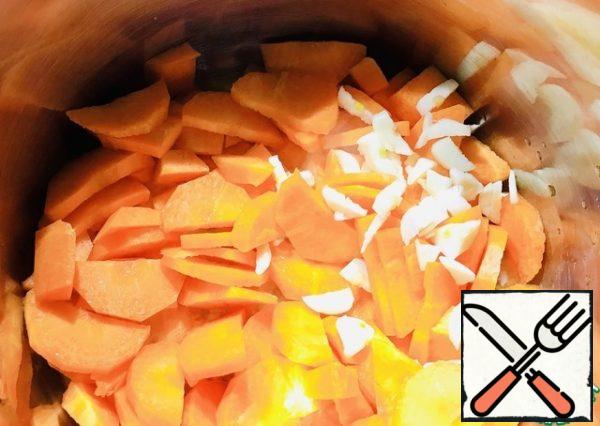 Put butter, carrots, and two cloves of garlic in a saucepan.