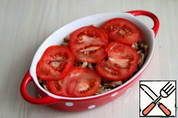 Next, put the plastic tomatoes on the meat. Add salt and pepper to taste.