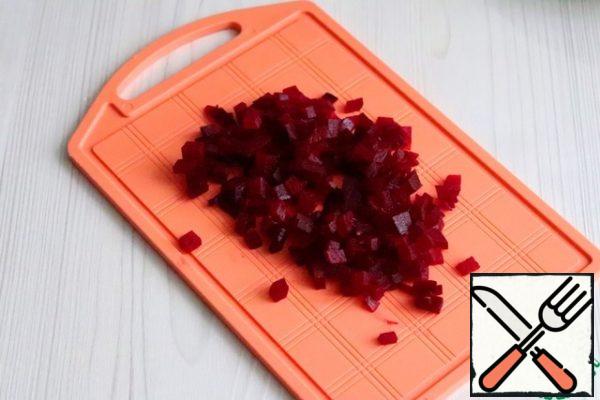 Boil the beets and cut them into small cubes.