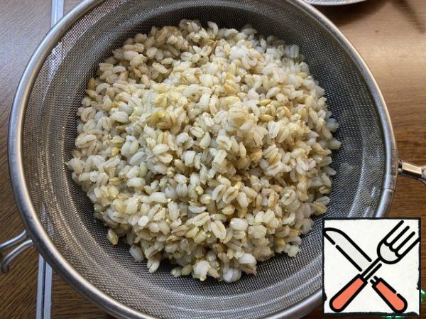 Meanwhile, the pearl barley is cooked, now you need to throw it on a sieve and rinse with boiled water.