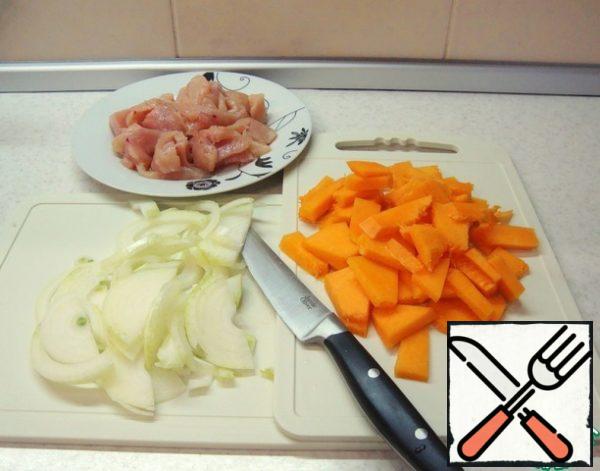 Cut the onion into half rings, the pumpkin into small plates, and the chicken breast into pieces.