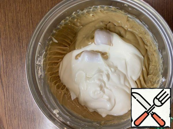Add sour cream and continue to beat with a mixer until smooth.
