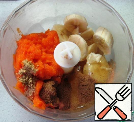In the bowl of a blender, combine the frozen banana slices, pumpkin puree, honey and spices-cinnamon and ginger.