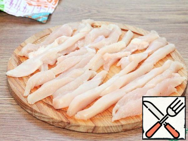 Marinate the chicken. Cut the chicken breast into small serving strips and place in a bowl.
