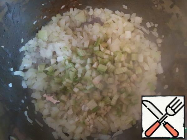 Add celery and garlic. As well as bell pepper and jalapeno, if you decide to use them.
Add some Cayenne pepper. Fry until the onion is soft.
In the middle of the process, add paprika.