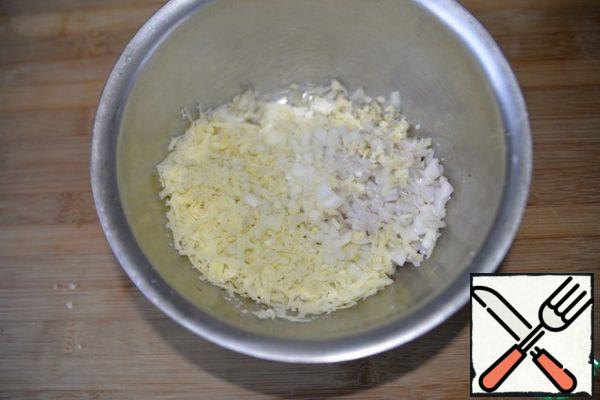 Add grated boiled potatoes. Put the finely chopped onion and garlic.