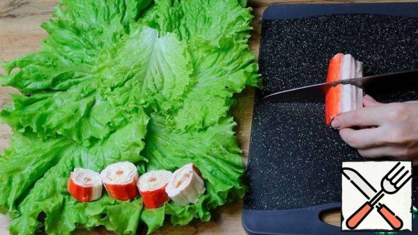 Cut into pieces. Place on lettuce leaves.