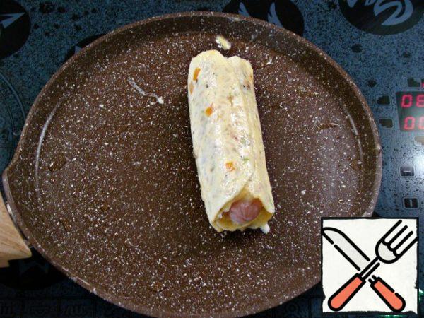 Carefully, using two spatulas, roll as much as possible into a tight roll. Then fry it lightly on all sides.