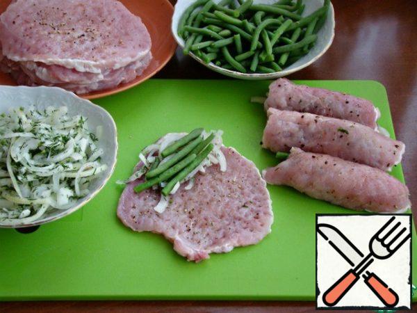 Put a little pickled onion and beans on each meat slice. Wrap in a thick roll.