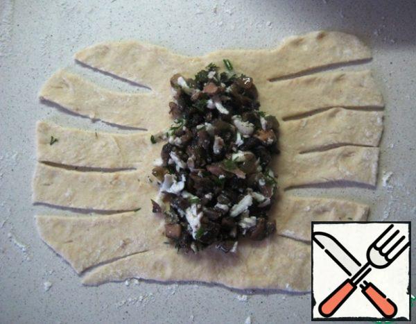Divide the dough into pieces (I got 12 pieces). Roll out the piece into a rectangle (approximately 14 x 20). Place the filling in the center and make incisions.