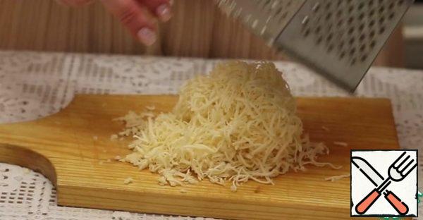 Grate the cheese on a fine grater.