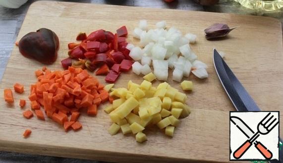 While the dough is resting, prepare the filling. Cut all vegetables into small cubes
