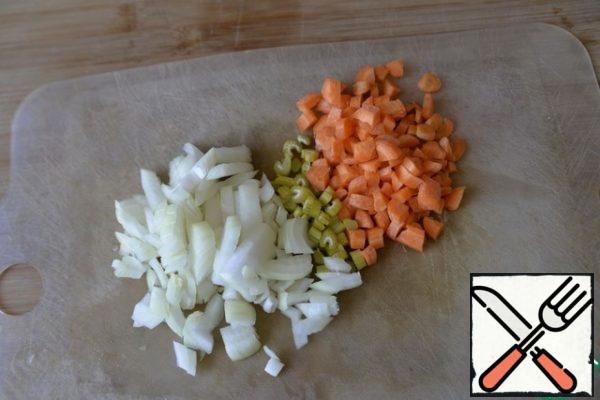 Vegetables are peeled, diced onions and carrots, celery straws.