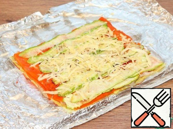 Three cheese on a large grater and sprinkle on top of the zucchini.