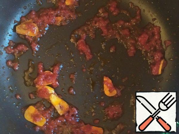 Add the chili and fry for a minute. Then add the tomato paste and fry for a couple of minutes.