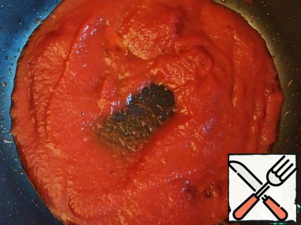 Add the tomato sauce, bring to a boil, add salt and simmer over low heat until thickened, about 10 minutes.
