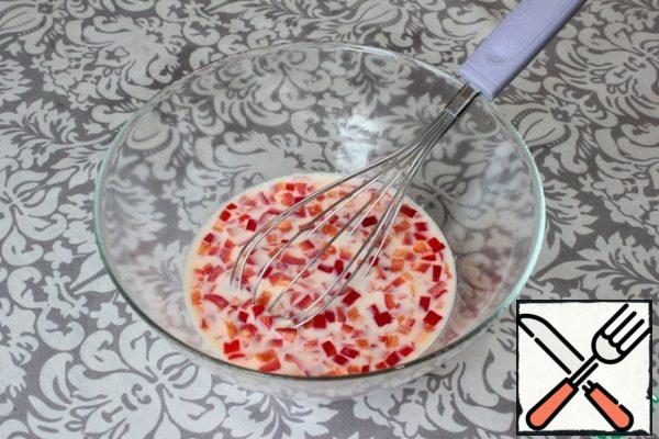 In the egg mixture, add finely chopped red sweet pepper (seeds and veins are removed in advance).
