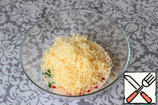 I grate the cheese on a fine grater. I add it to the dough. Stir.