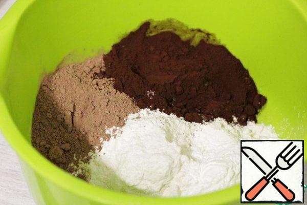 In a large bowl, add the flour, cocoa powder (I have regular and alkalized) and baking powder.
Mix well with a whisk.