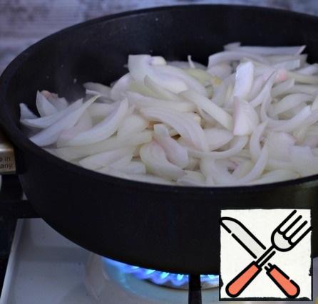 Add the onion cut into large feathers to the pan with the chicken and mix. Cook the chicken and onion, stirring occasionally, for 5-6 minutes.
