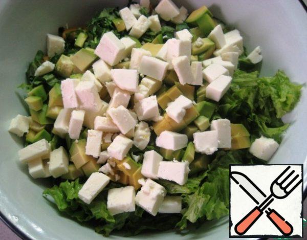 Also, cut Adyghe cheese into small pieces and add it to the salad.