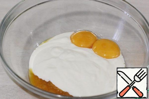 Add two egg yolks.