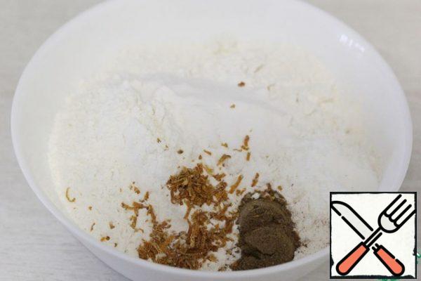 In another bowl, add the flour, baking powder, baking soda, and spices. Stir.
If you have dried zest, add it to the flour, if fresh (which is preferable), add it in the previous step.

From spices, I suggest taking cinnamon, ground ginger and nutmeg. The proportions to your taste or you can take about 3/4 tsp cinnamon and 1/8 tsp of ground ginger and nutmeg. Or you can take a ready-made spice mix in the store.