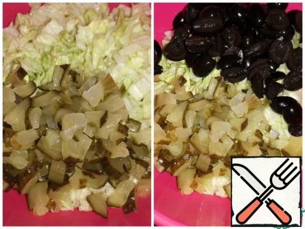 Cucumbers cut into pieces, olives in half.