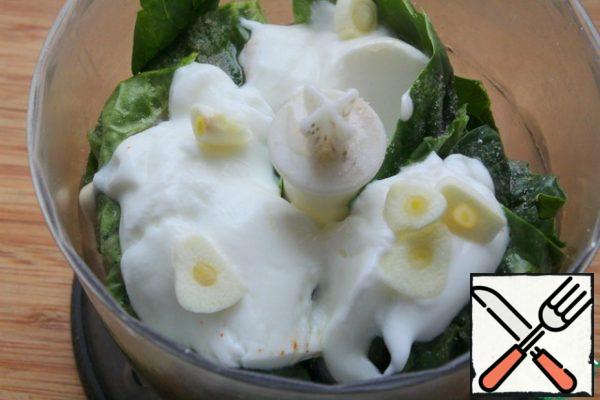 Combine the spinach, salt, yogurt and garlic clove in a blender. adjust to taste.
