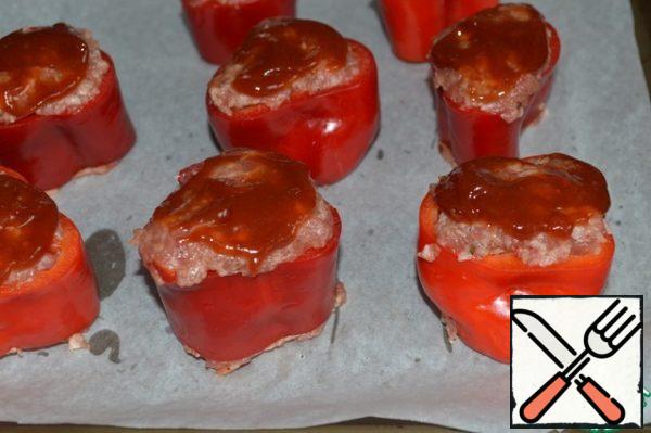 Stuff the pepper rings and place them on a baking sheet covered with parchment.
Mix the ketchup and brown sugar and brush the surface of the peppers.
Send to a preheated 180*C oven.
Bake for 35 minutes, then sprinkle with grated cheese and bake for another 5-8 minutes.