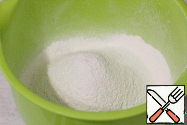 Sift the flour, baking soda, and baking powder into a large bowl.