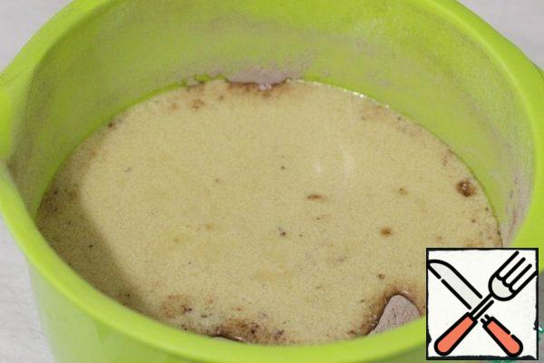 Pour this mixture over the dry ingredients and mix quickly.