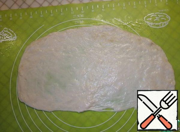 Stretch each part of the dough into an oval shape with your hands.