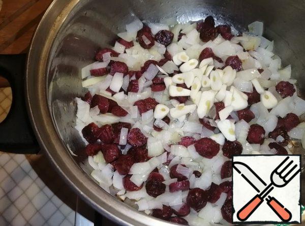 Add coarsely chopped garlic. Fry for 1-2 minutes.