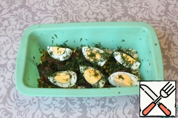 Then I put half of the boiled eggs and sprinkle with half of the dill.
I fill the top fill to close the bulk of the products already laid out in the form.