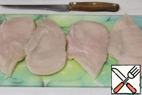 Cut the chicken fillet lengthwise into two parts, if necessary, beat off in thick places.