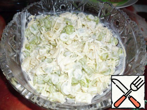 RUB the garlic on a fine grater and add to the rest of the ingredients. Mix everything, add mayonnaise, and mix again. You can sprinkle ground nuts (pine or walnut) on top.