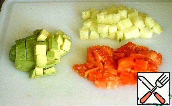 Peel the cucumber and avocado and cut into cubes. Slice the tomato as well.