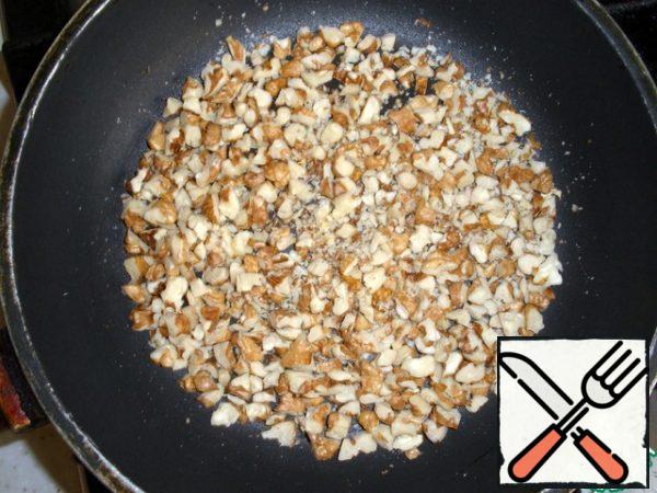 Fry the nuts until lightly browned.