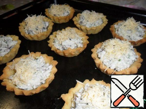 Sprinkle each basket with grated cheese and lightly bake.