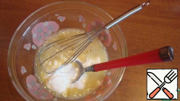 Add sour cream to the eggs. Stir.