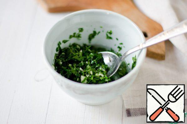 For the dressing, finely chop the garlic, parsley and coriander, put them in a bowl, add the walnut oil, wine vinegar, ground black pepper, and mix.