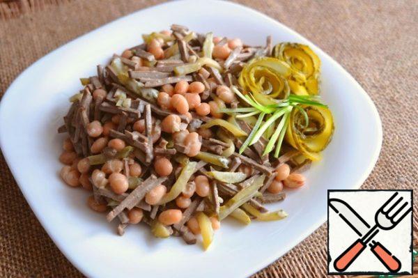 The salad is decorated with green onion feathers, the roses are made from pickled cucumbers.