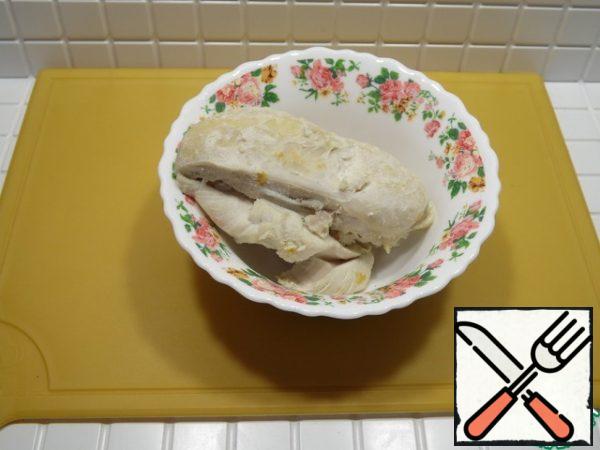 Boil the chicken breast and cut it into small cubes.