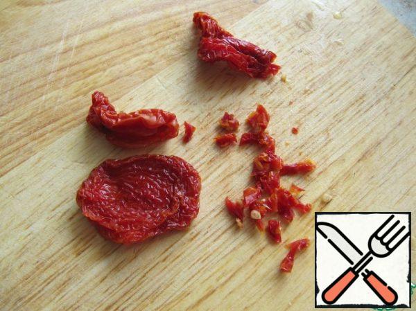 Cut sun-dried tomatoes into small pieces.